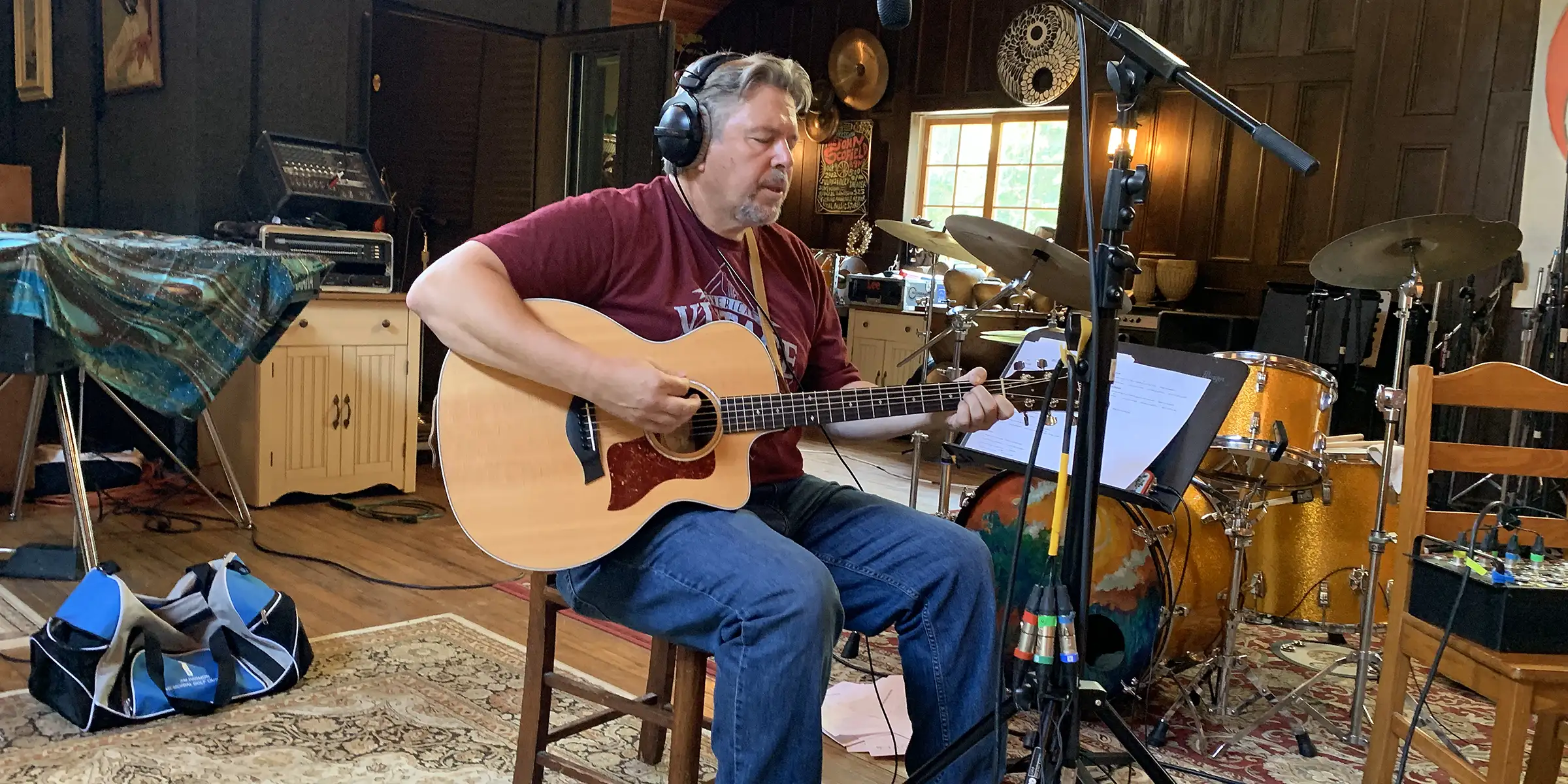 Anthony Giaccio in the studio with an acoustic guitar.