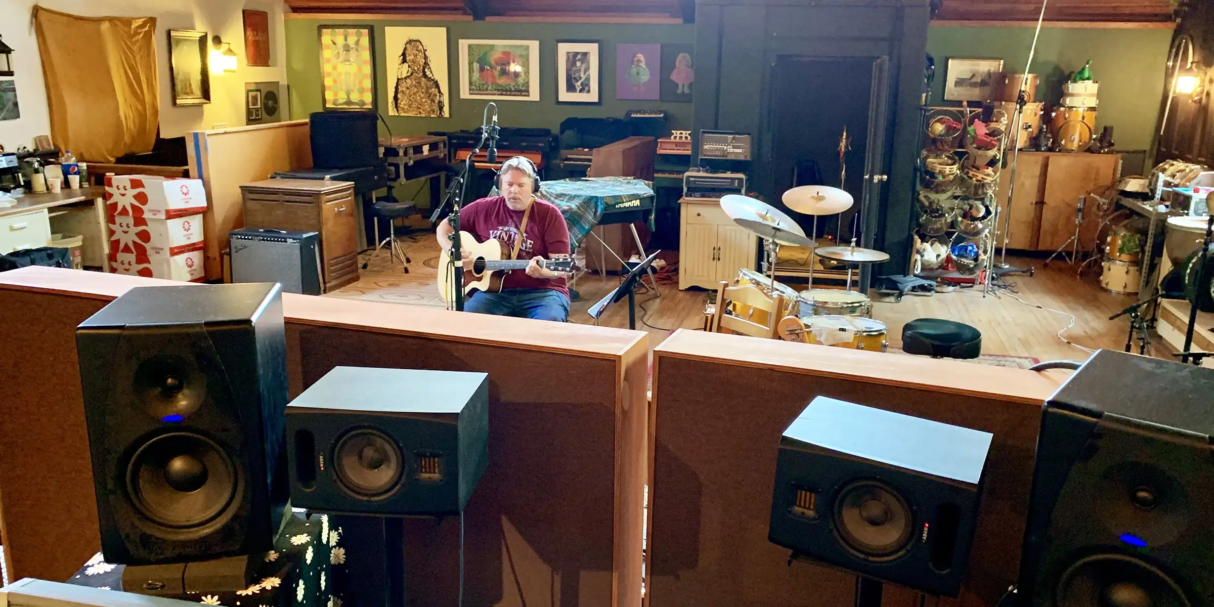 Anthony Giaccio in the studio with an acoustic guitar.